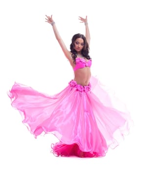 Full length portrait of beautiful dancer in pink costume performing oriental dance. Isolated on white