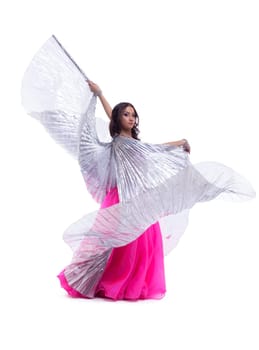Full length portrait of beautiful dancer performing oriental dance with silver wings isolated