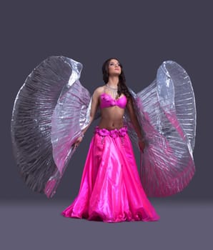 Full length portrait of young dancer performing oriental dance