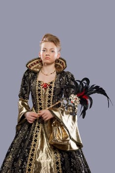 Full length portrait of young girl in carnival costume middle age with mask