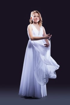 Full length portrait of young woman in beautiful long dress
