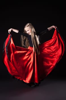 Full length portrait of happy little girl performing hispanic dance