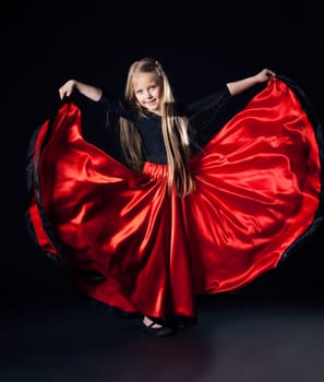 Full length portrait of happy little girl performing hispanic dance