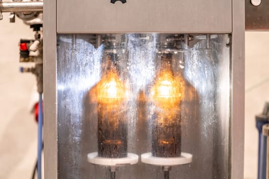 machine for washing and filling glass bottles with beer. High quality photo