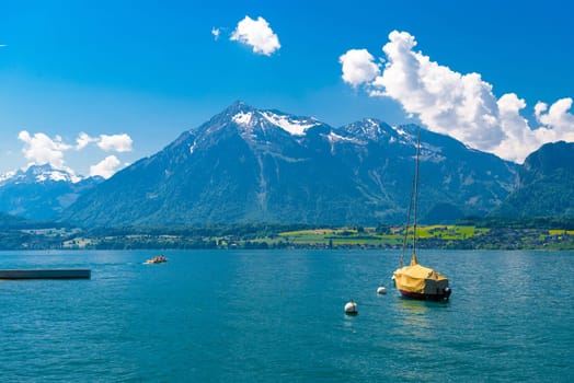 Boats and mountains on the Lake Thun, Thunersee Bern Switzerland.