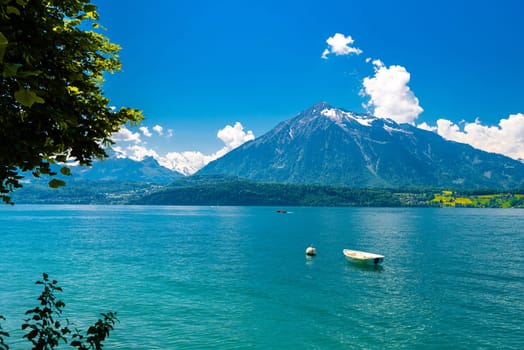 Boats and mountains on the Lake Thun, Thunersee Bern Switzerland.