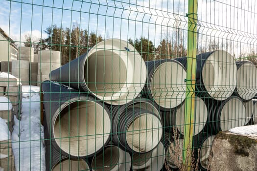 large plastic drainage pipes on the construction store site. Large industrial plastic drainage pipes. corrugated pipes at the production site