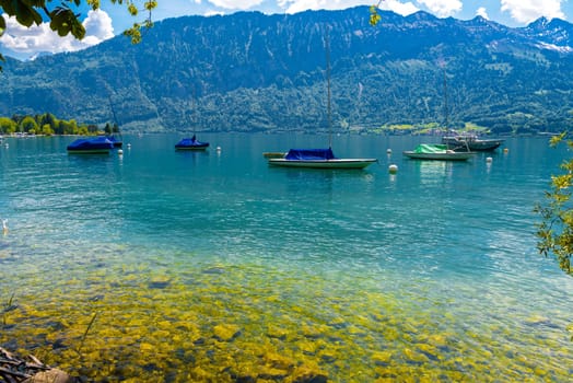 Boats and mountains on the Lake Thun, Thunersee Bern Switzerland.