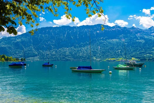 Boats and mountains on the Lake Thun, Thunersee Bern Switzerland.