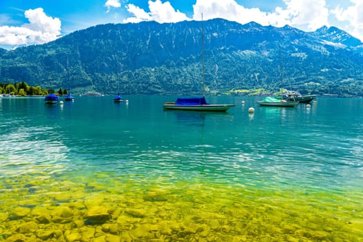 Boats and mountains on the Lake Thun, Thunersee Bern Switzerland.