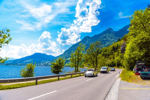 Road with cars near the lake with mountains, Alpnachstadt, Alpnach Obwalden Switzerland.