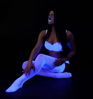 Full length portrait of sexy go-go girl in dark