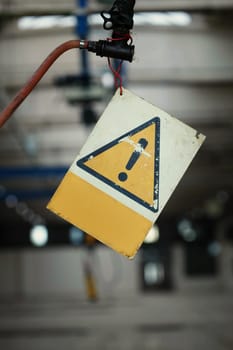 Hanging old exclamation alert sign, close-up