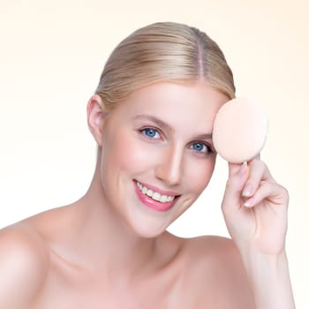 Closeup personable beautiful natural soft makeup woman using powder puff for facial makeup concept. Cushion foundation applying on young girl face in isolated background.