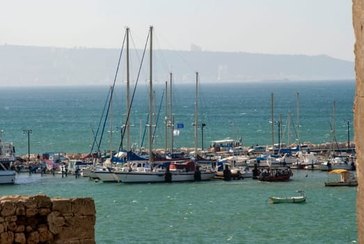 Large and small boats stand on the berth await strong heat and dust that Hamsin