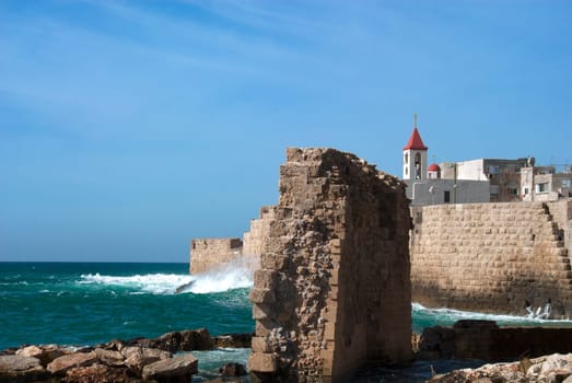 The waves of the Mediterranean Sea crash against the walls of the old fortress