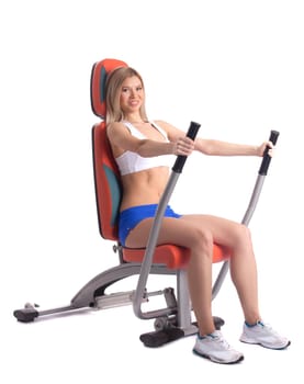 Blonde young woman on hydraulic exerciser. Isolated on white