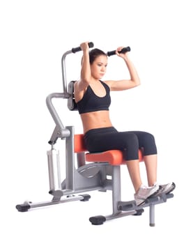 Young woman on orange hydraulic exerciser. Isolated on white