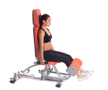 Beautiful woman exercising on gym machine, isolated on white
