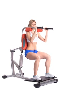 Sporty woman training on isodynamic exerciser, isolated on white