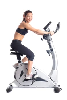 Brunette woman on bike exerciser. Isolated on white