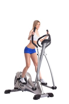 Slim blonde practicing on trainer, isolated on white