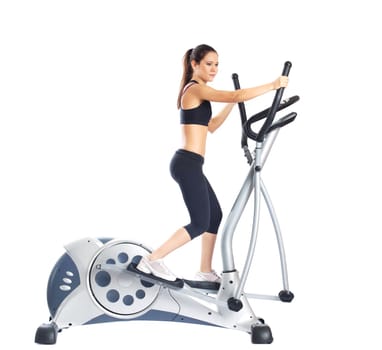 Pretty brunette doing exercises on gym equipment, isolated on white