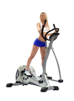 Pretty blonde woman on exerciser. Isolated on white