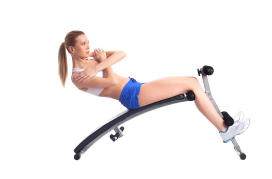 Sporty young woman on exerciser. Isolated on white