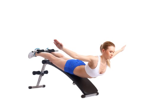Young blonde woman on exerciser. Isolated on white