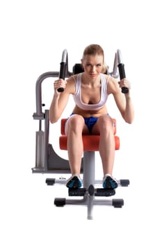 Athletic woman on hydraulic trainer, isolated on white