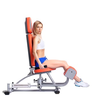 Young woman on isodynamic exerciser. Isolated on white