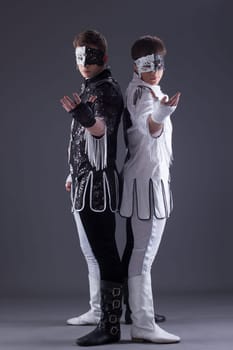 Attractive men in masquerade costumes posing in studio