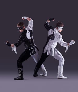 Men posing in carnival costumes on gray background