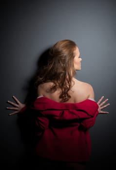 Studio portrait of young woman in pink jacket