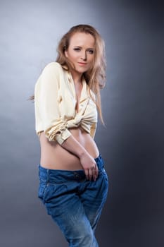 Studio portrait of woman in beige blouse and jeans