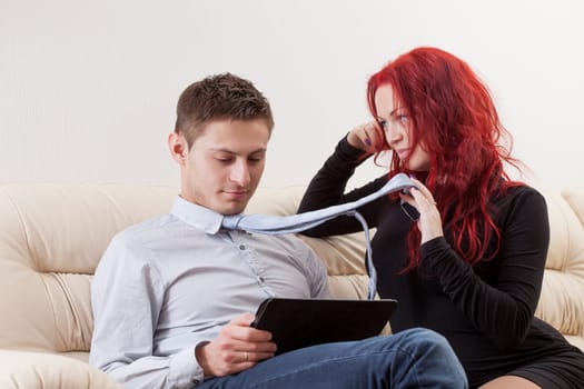 Pretty young woman with red hair flirting with man