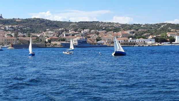 yachts are moored near the sea against the backdrop of mountains in the haze. High quality photo