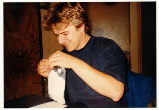 THE CZECHOSLOVAK REPUBLIC - CIRCA 1990s: Retro photo shows man at the party.