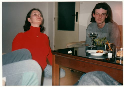 THE CZECHOSLOVAK REPUBLIC - CIRCA 1990s: Retro photo shows people drink wine at the table.