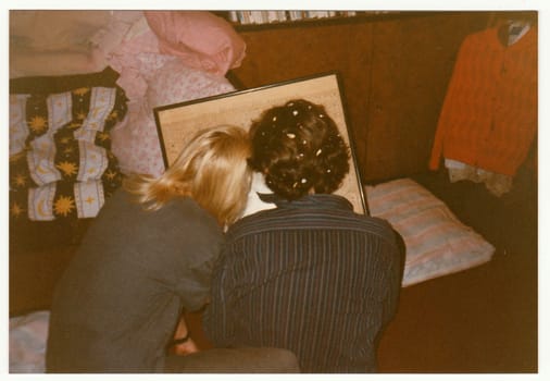 THE CZECHOSLOVAK REPUBLIC - CIRCA 1990s: Retro photo shows boy and girl look at the picture-map.