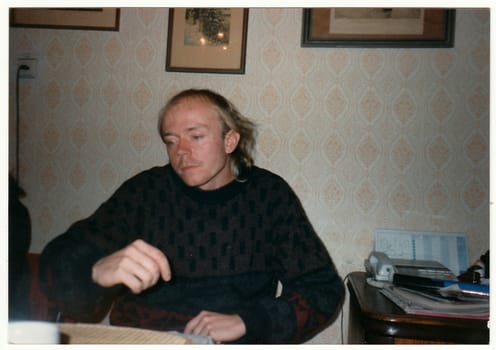 THE CZECHOSLOVAK REPUBLIC - CIRCA 1990s: Retro photo shows young man sits at the table.