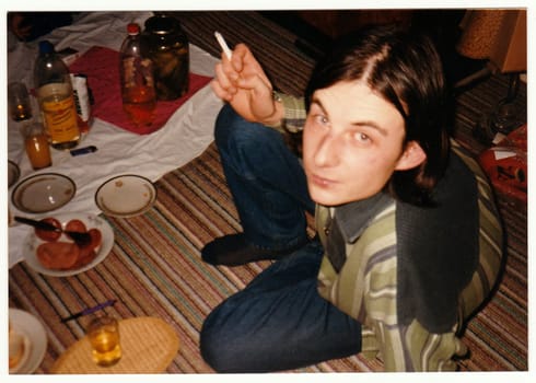 THE CZECHOSLOVAK REPUBLIC - CIRCA 1990s: Retro photo shows man at the home party.