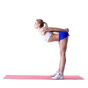 Image of sporty blonde posing on mat in studio