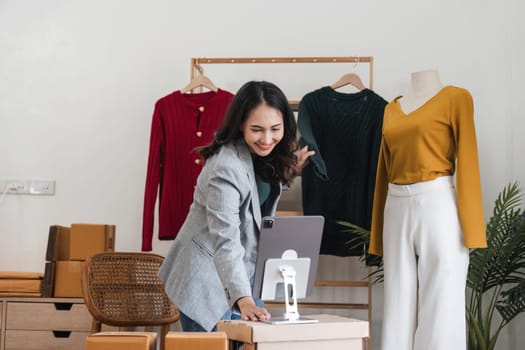 Female stylist Successful Fashion Business. Portrait of Smiling Asian Designer stylish standing and working at fashion studio. Portrait of fashion designer in office.