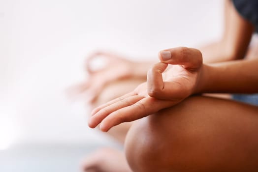 I do yoga for a better mind and body. an unrecognizable woman practising yoga against a white background