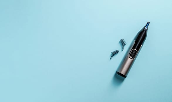 Top view of nose and ear hair trimmer isolated on blue background