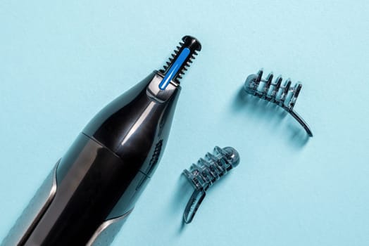 Top view of nose and ear hair trimmer isolated on blue background