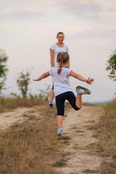 mother and daughter walking outdoors