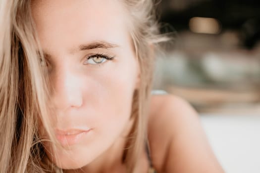Happy woman portrait in cafe. Boho chic fashion style. Outdoor photo of young happy woman with long hair, sunny weather outdoors sitting in modern cafe